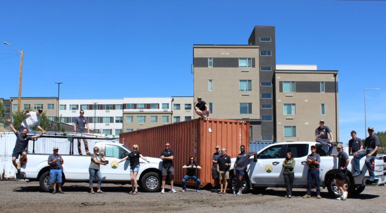 Thrive Roofing Co Team posing in front of Denver headquarters